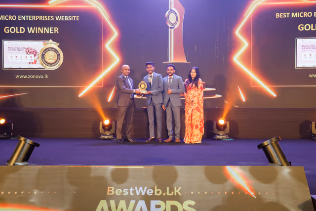 Gold Winner, Best Micro Enterprises Website of the Year, with zonova.lk on the screens as the award is presented.